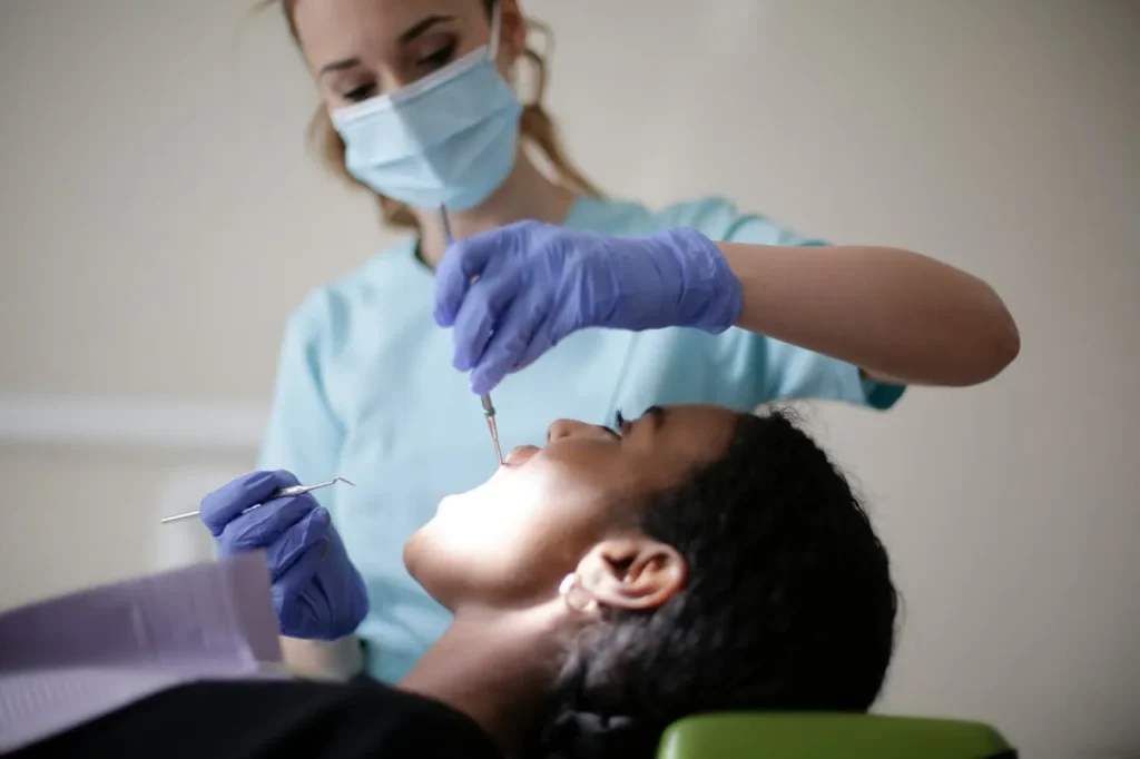 Dental hygienist examining a patient during an appointment for bleeding gums.