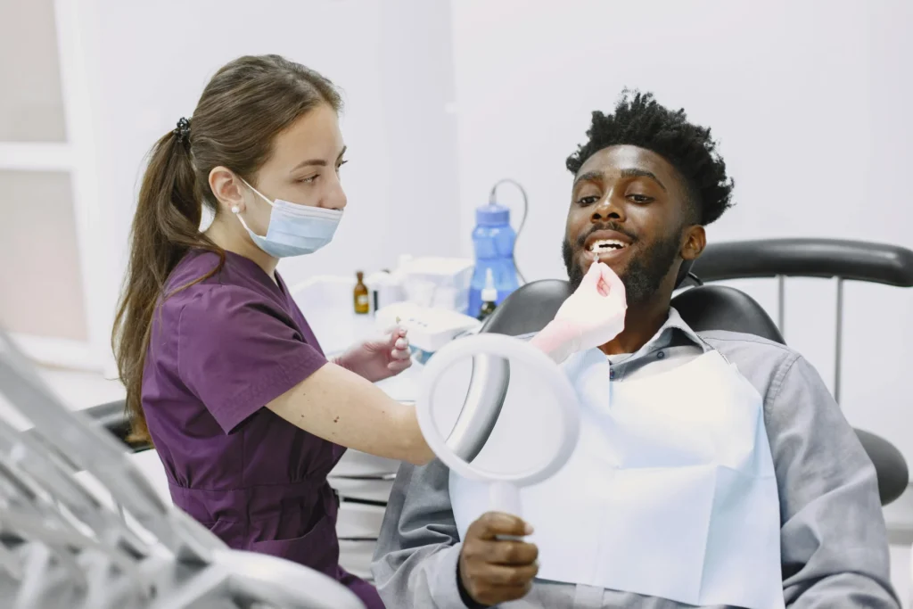 Dentist checking a patient’s smile during a cosmetic consultation.