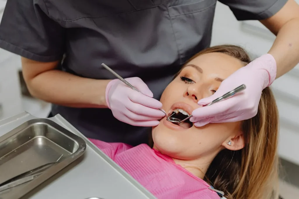 Dentist checking a patient’s teeth before professional whitening treatment.